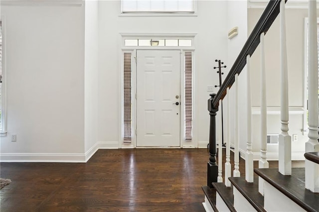 entrance foyer featuring stairway, wood finished floors, and baseboards