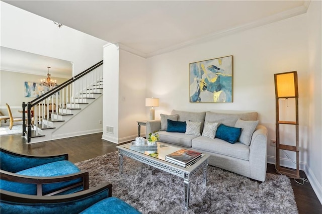 living room with a chandelier, crown molding, stairway, and wood finished floors