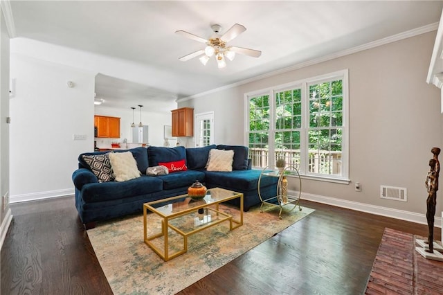 living area featuring ceiling fan, dark wood-style flooring, visible vents, baseboards, and ornamental molding