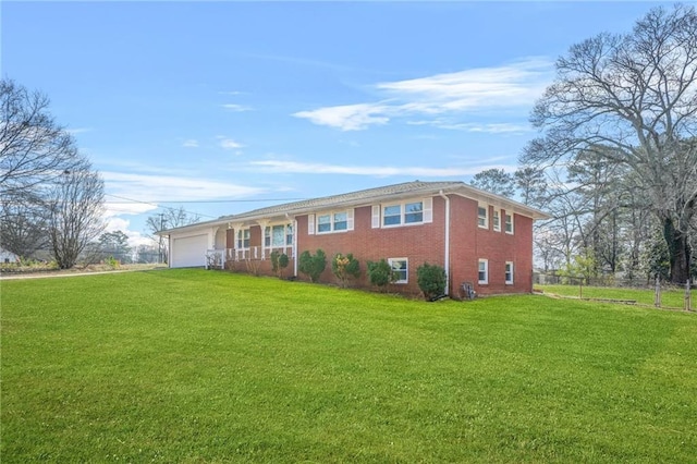 view of front of home with a garage and a front lawn