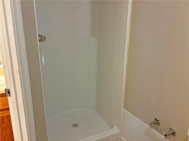 bathroom featuring vanity, hardwood / wood-style flooring, and walk in shower