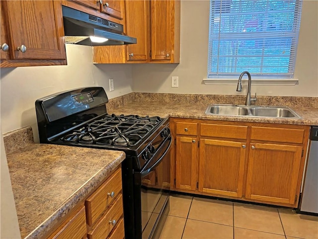 kitchen featuring gas stove, sink, light tile patterned flooring, and dishwasher