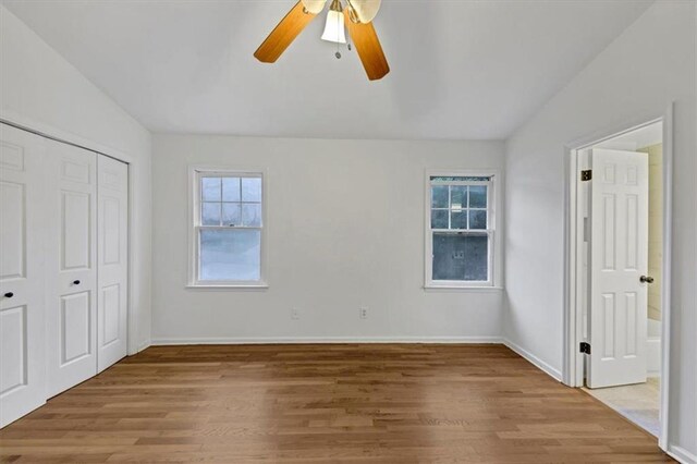 unfurnished bedroom featuring vaulted ceiling, ceiling fan, and hardwood / wood-style flooring