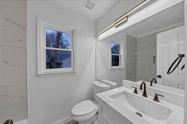 bathroom with toilet and vanity