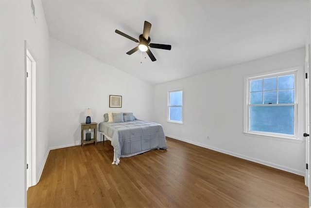 bedroom featuring vaulted ceiling, ceiling fan, and hardwood / wood-style floors