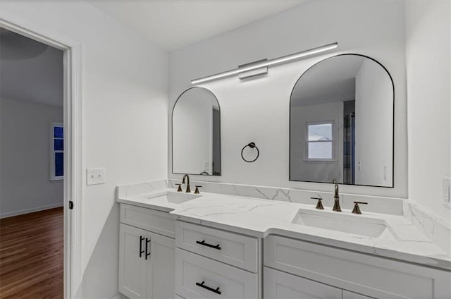 bathroom with hardwood / wood-style floors and vanity