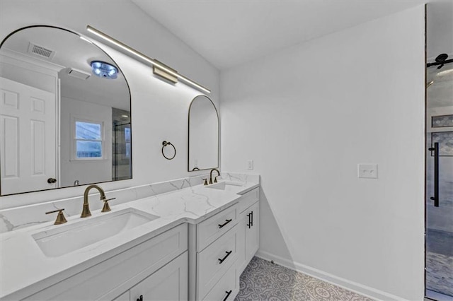 bathroom featuring a shower with door and vanity