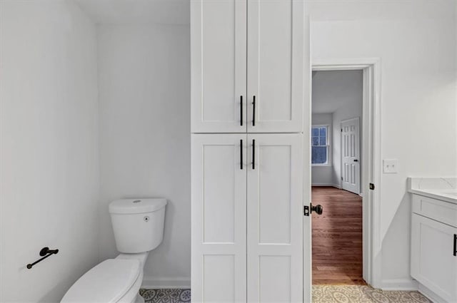 bathroom with toilet and vanity