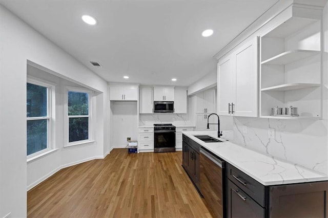 kitchen featuring sink, stainless steel appliances, white cabinetry, and dark brown cabinets