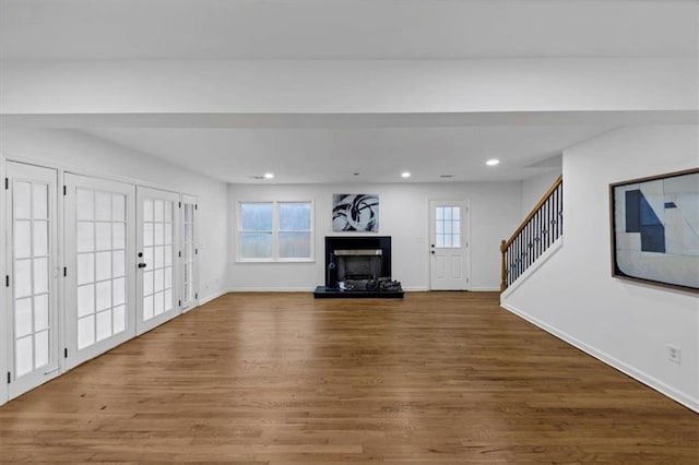 unfurnished living room featuring french doors and wood-type flooring