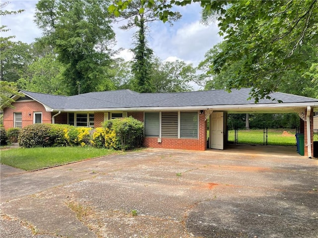 single story home with brick siding, aphalt driveway, and a carport
