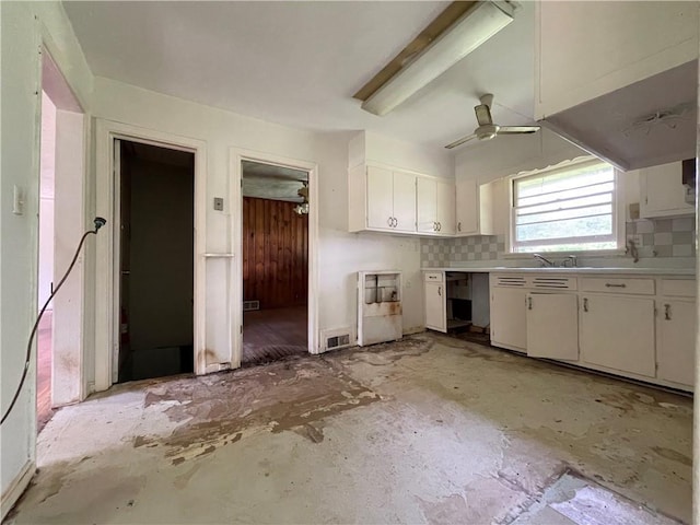 kitchen featuring ceiling fan, a sink, light countertops, white cabinetry, and visible vents