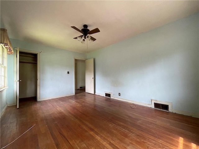 unfurnished bedroom with visible vents, baseboards, and hardwood / wood-style floors