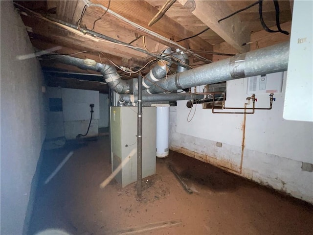 unfinished basement featuring heating unit and water heater