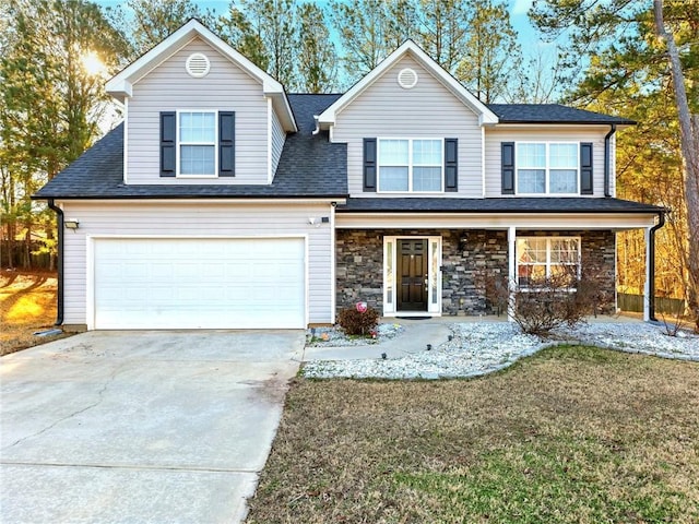 traditional home with driveway, a garage, stone siding, a porch, and a front lawn