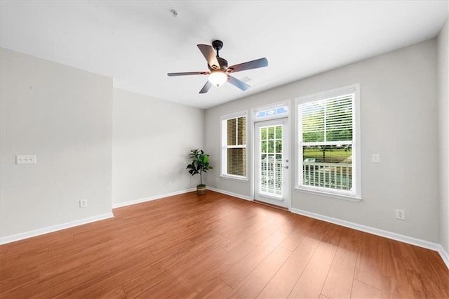 spare room featuring ceiling fan and light hardwood / wood-style flooring