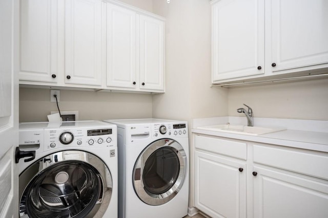 laundry area featuring a sink, cabinet space, and washer and dryer