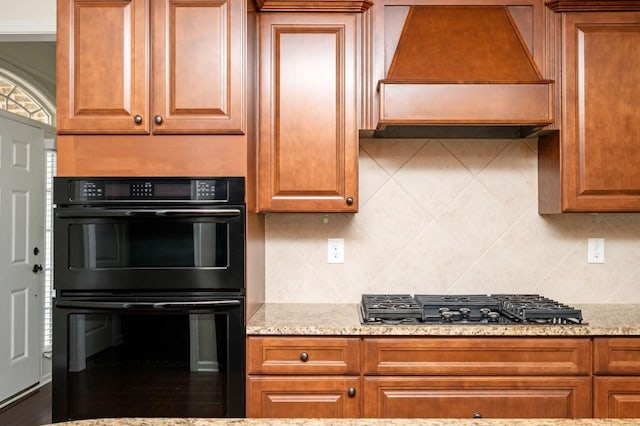 kitchen featuring dobule oven black, gas stovetop, custom exhaust hood, and backsplash