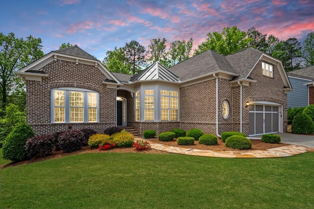 single story home with brick siding, a garage, driveway, and a front lawn