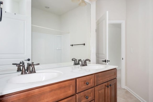 full bath with double vanity and a sink