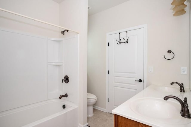 bathroom with double vanity, a sink, shower / bathing tub combination, and toilet