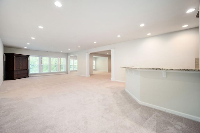 interior space with recessed lighting, baseboards, and light colored carpet