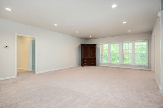 unfurnished room featuring light colored carpet, recessed lighting, and baseboards