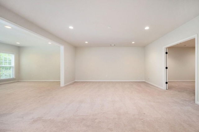 unfurnished room featuring recessed lighting, baseboards, and light carpet