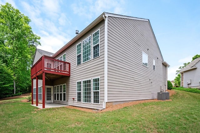 back of house with a deck, a yard, a patio area, and central AC