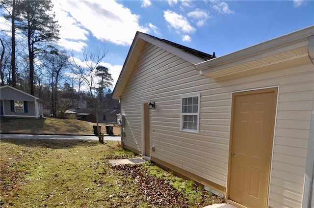 view of side of property with a yard