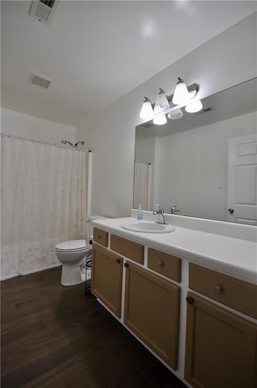 bathroom featuring vanity, hardwood / wood-style flooring, and toilet