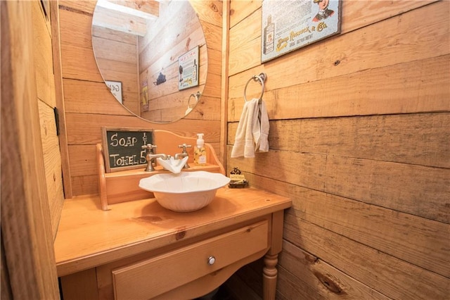 bathroom with wooden walls and oversized vanity