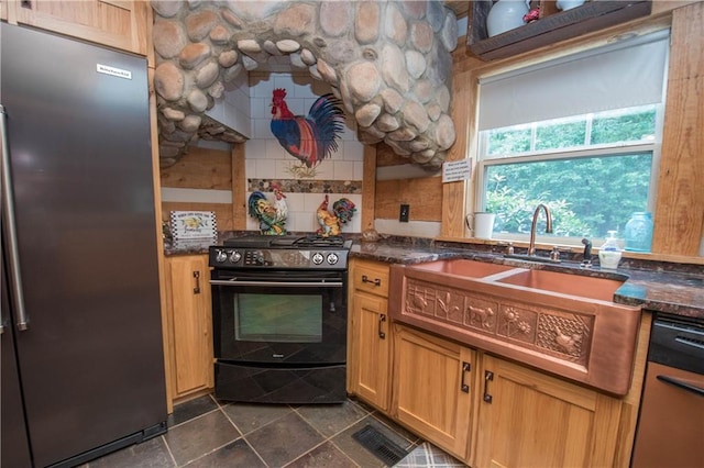 kitchen with appliances with stainless steel finishes, dark tile floors, and tasteful backsplash