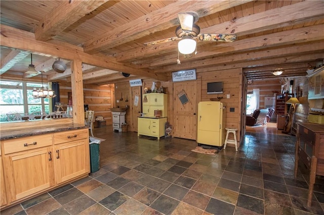 kitchen featuring beam ceiling, ceiling fan with notable chandelier, hanging light fixtures, and a healthy amount of sunlight