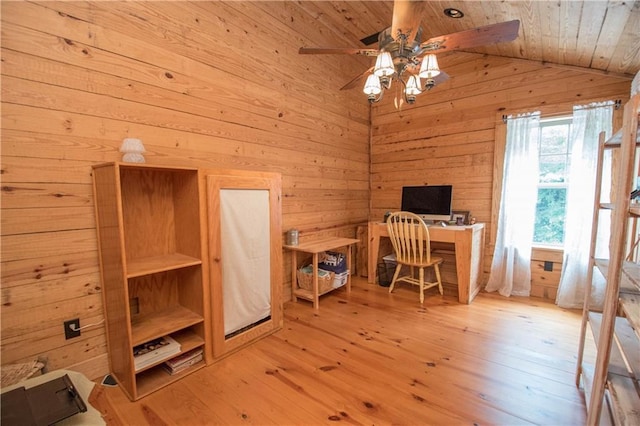 office area with vaulted ceiling, ceiling fan, wood ceiling, wooden walls, and light hardwood / wood-style flooring