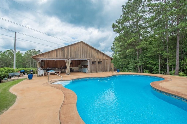 view of swimming pool featuring a patio area