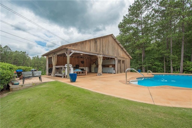 view of swimming pool with a lawn and a patio