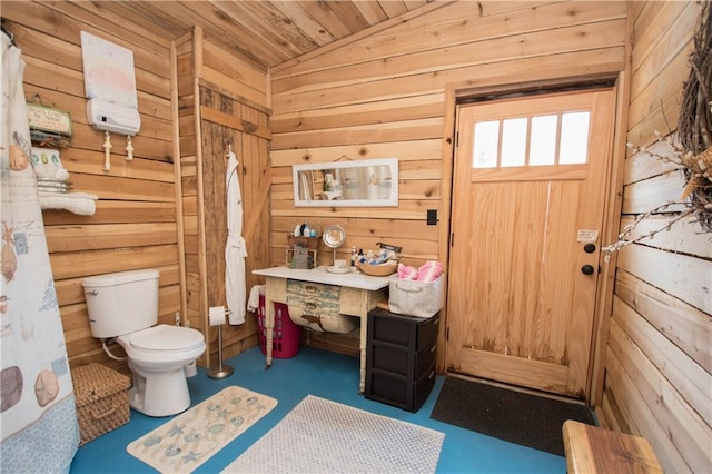 bathroom with wooden walls, toilet, vaulted ceiling, and wood ceiling