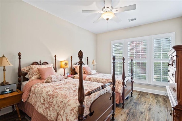 bedroom featuring wood finished floors, baseboards, and ceiling fan