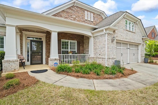 craftsman-style home featuring a porch, brick siding, concrete driveway, and a garage