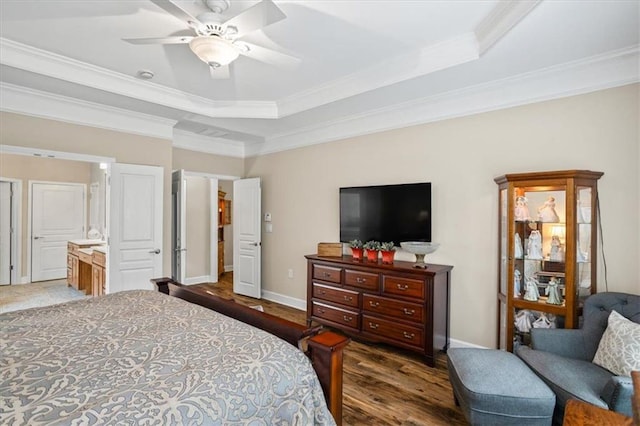 bedroom with a raised ceiling, crown molding, wood finished floors, baseboards, and a ceiling fan