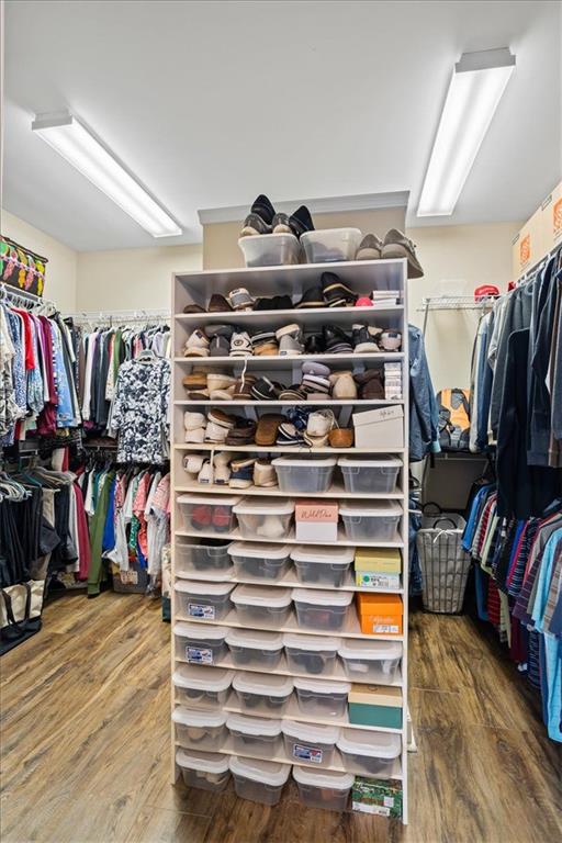 spacious closet with wood finished floors
