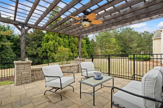view of patio with an outdoor hangout area, view of scattered trees, ceiling fan, and a pergola