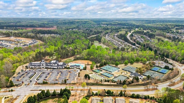 aerial view of property and surrounding area with a forest