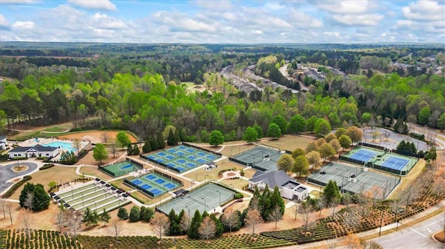 aerial view of a heavily wooded area and a pool