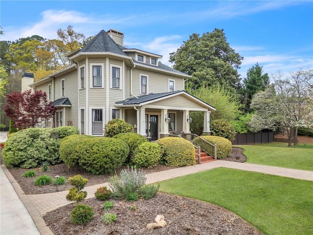 victorian-style house featuring a porch and a front lawn