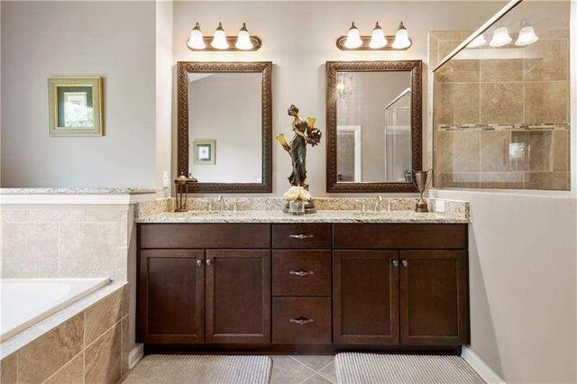 bathroom with tile patterned floors, vanity, and independent shower and bath