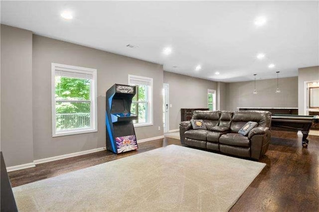 living room featuring dark hardwood / wood-style floors and billiards