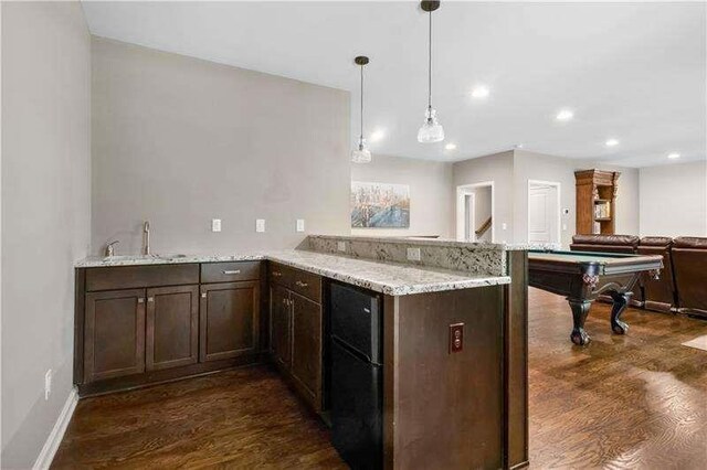 kitchen with pendant lighting, dark wood-type flooring, sink, pool table, and kitchen peninsula