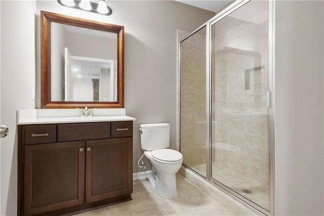 bathroom with toilet, vanity, and walk in shower